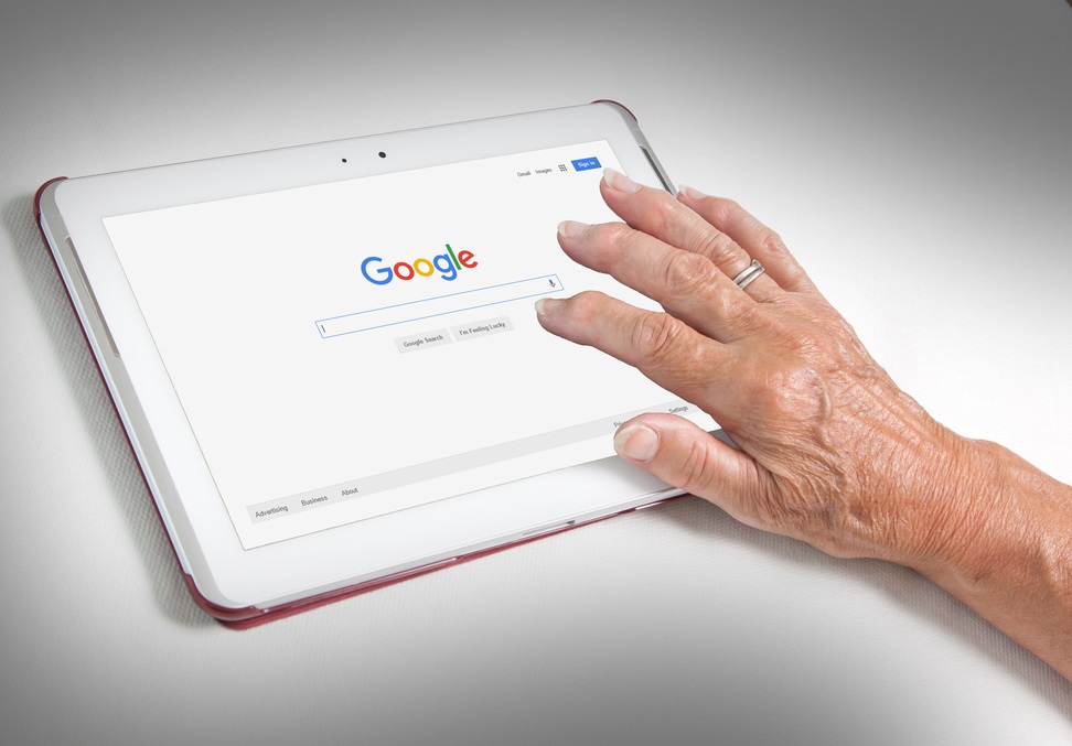 A person using Google on a tablet.