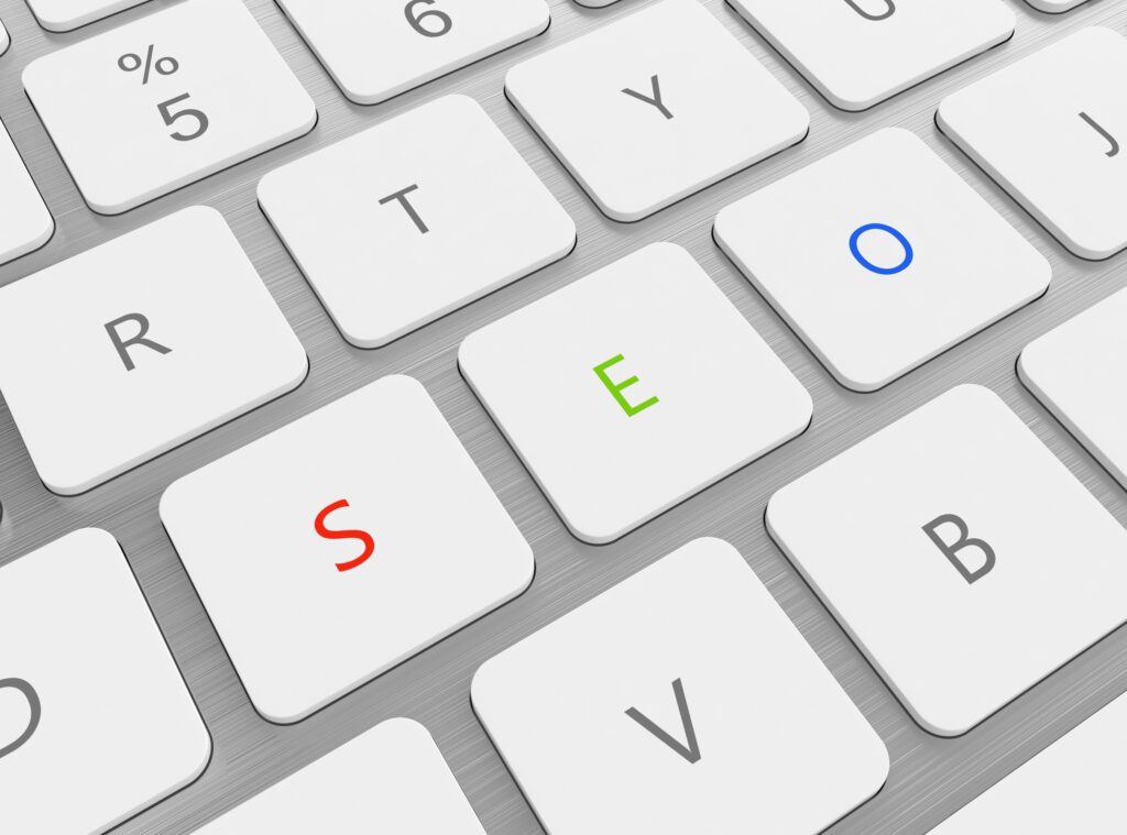 3D illustration of keyboard with red green and blue SEO buttons to illustrate Why Hire An SEO Agency? To Unleash Digital Marketing’s Power